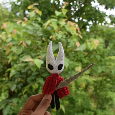 My amigurumi version of Hornet from the indie game Hollow Knight. She has wired limbs for posing and a handmade needle, making her a perfect collectible for fans of the game.