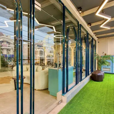 A look at our studio's facade from the inside, showing the seamless fusion of our serene interior with the world outside. The design creates a tranquil, inspiring atmosphere.