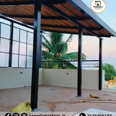 A Mangalore tile pergola under construction on a rooftop. This image shows the strong metal framework supporting the traditional clay tiles, a combination that ensures both authentic style and long-lasting durability.