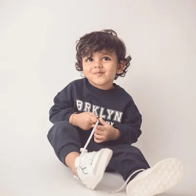 This little guy looks like a model in his casual sweatshirt. We capture kids' natural charm and style in our individual portrait sessions.
