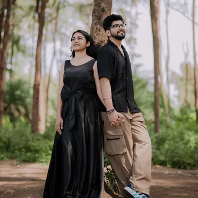 A quiet moment of reflection for the couple in a beautiful forest setting. The tall trees create a sense of intimacy and seclusion.
