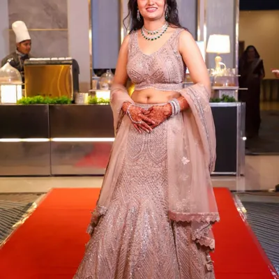 A full-length shot of my gorgeous client at her engagement. The shimmery lehenga is paired with a soft glam makeup look and loose curls for an elegant and modern feel.
