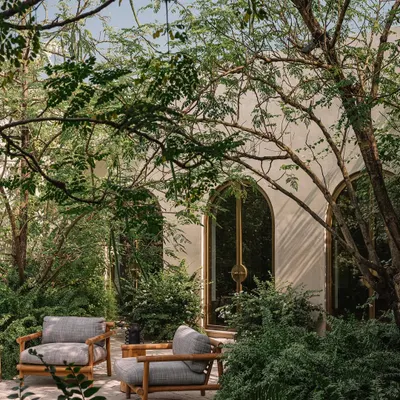 The DUA Villa is nestled within its verdant landscape, with outdoor seating areas that feel like natural extensions of the interior. The architecture is designed to frame nature, creating quiet moments for contemplation amidst the foliage.