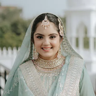 The pure joy of an Anand Karaj bride. This look is all about enhancing her natural beauty with soft makeup that radiates happiness and serenity.