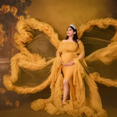 A regal portrait featuring our popular yellow butterfly gown. The fabric extends like wings against a floral backdrop, creating a powerful and artistic statement for a solo maternity shoot.