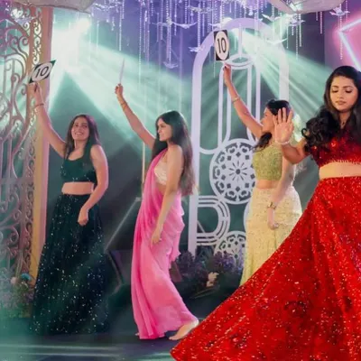 A perfect 10 for the bridesmaids! I love incorporating fun props and concepts into the choreography to make your sangeet performances even more memorable and interactive.