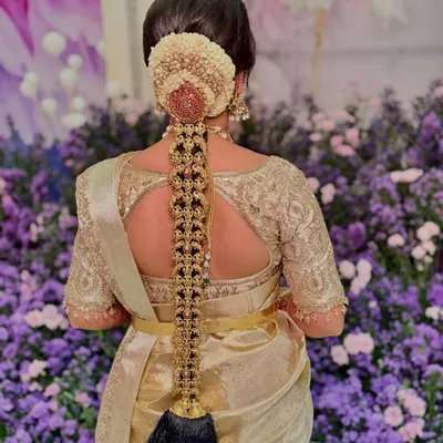 The breathtaking detail of a traditional South Indian bridal braid for Sushmitha, adorned with exquisite temple jewelry. This is wearable art.