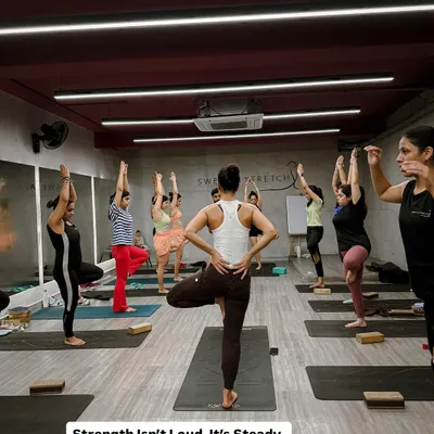 A full Ashtanga class holding Vrikshasana (Tree Pose). This image captures the collective focus and steady strength that defines our practice. Here, it's just you versus the chaos inside.
