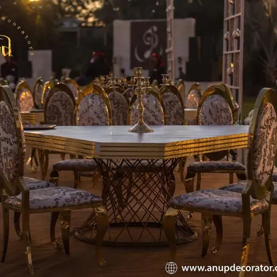 Guest comfort and style are paramount. This image showcases our luxury seating options, featuring ornate gold-framed chairs with patterned fabric and elegant square tables, perfect for a sophisticated reception dinner.