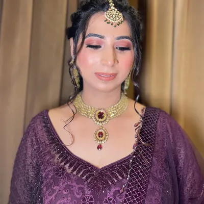 Elevating beauty with a professional touch. This look for a family function features a warm, shimmery pink eyeshadow and a glossy nude lip, creating a sophisticated and polished appearance.