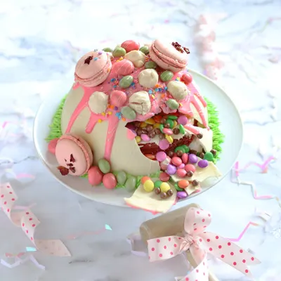 Make birthdays extra exciting with our White Chocolate Dome Pinata Cake. It has a hard chocolate shell that you hammer open to reveal a surprise M&M filling inside!