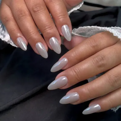 This is my popular pearly chrome finish. It gives the nails a beautiful, high-shine, iridescent look that is both trendy and timeless. It looks stunning on these long, almond-shaped nails.