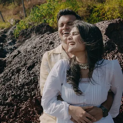 A moment of pure, uninhibited laughter on the rocky shores of Goa. We believe the best pre-wedding photos are the ones that capture your genuine joy.