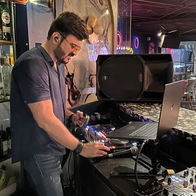 Focused and in the zone, getting the mix just right. Every track I select is meant to create a specific mood and keep the energy flowing.