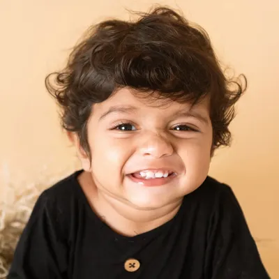 That cheesy, scrunchy-nosed grin is absolutely priceless. I live for capturing these perfectly imperfect expressions that show your child's true personality.