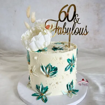 A striking beauty for a 60th birthday. I used a palette knife to create these beautiful teal and white buttercream flowers, accented with gold for a touch of elegance.