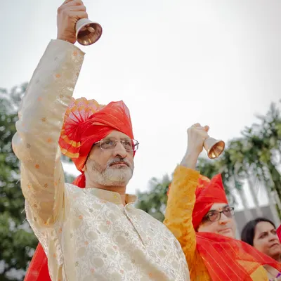The fathers of the bride and groom ringing bells during the Maharashtrian wedding ceremony.
