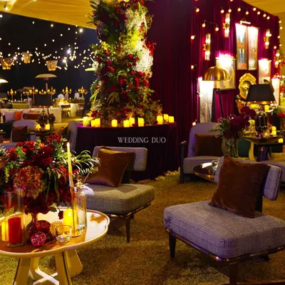 A glimpse into our Speakeasy Sangeet, where moody lighting, deep red florals, and plush lounge seating created a timeless and intimate vibe. Even a bit of rain couldn't dampen the magic of this candlelit evening.