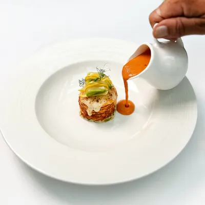 Our paneer lasagna is a study in comfort and creativity. Layers of soft paneer are stacked with smoked aubergine and finished with a rich goji berry makhani sauce poured tableside.