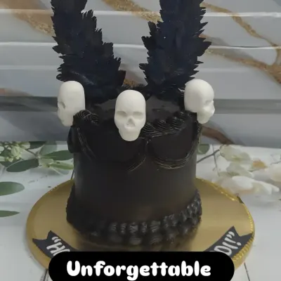 A dark and dramatic chocolate cake. This creation is for the true chocolate lover, featuring black feather-like chocolate shards and white chocolate skulls.