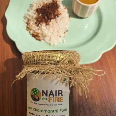 This is my magical Chammanthi Podi, showcased with its most classic pairing: a simple mound of rice. The jar itself holds a dense, smoky, and tangy chutney powder that is a must-have for adding a taste of home to any meal, anywhere you go.