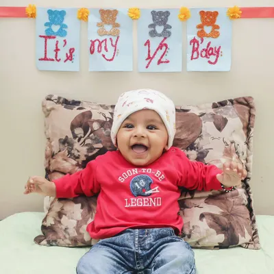Celebrating a half-birthday is a wonderful milestone. This little legend's smile shows just how much fun we have during these special baby photoshoots.