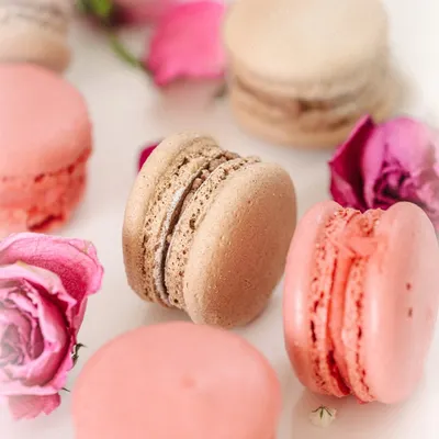 A dreamy, light, and airy shot of pink and beige macarons. This style is perfect for delicate pastries and creates a soft, romantic mood.
