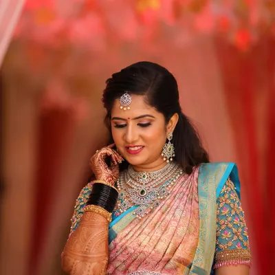 Rashmi looking absolutely breathtaking for her reception. The makeup features soft, shimmering eyes and is paired with stunning diamond jewelry for a truly glamorous look.