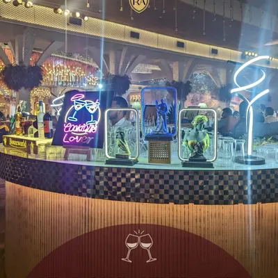 I help you sip, savor, and celebrate with a stylish bar experience. This setup features modern decor, neon lighting, and a full range of beverages to create a chic and inviting focal point for your event.