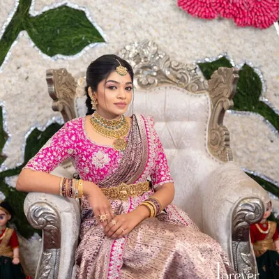 Our bride looking regal in her complete wedding ensemble. The heavily embroidered pink zardozi blouse perfectly complements her lavender and silver Benarasi silk saree, creating a picture-perfect moment.