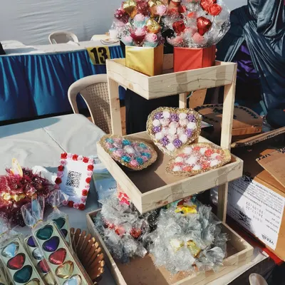 My stall display featuring different gifting options. You can see the chocolate bouquets on top and the heart-shaped trays filled with assorted chocolates below. These are very popular as wedding return gifts or party favors.
