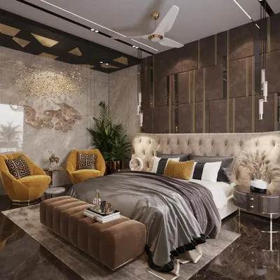 This master bedroom in Lucknow is a study in opulent design, featuring dark, textured wall panels with gold accents and a tufted wingback headboard. The mustard yellow armchairs add a rich, jewel-toned contrast to the moody and luxurious space.