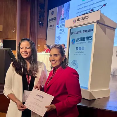 Receiving a certificate of participation at Aesthetics 2024. I was also thrilled to win a mentorship award at this event, which will allow me to further my training in South Africa.