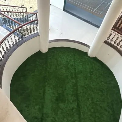 This project showcases a unique indoor application of artificial grass. I installed a circular turf area in a building's atrium, adding an unexpected and refreshing pop of green to the common space.