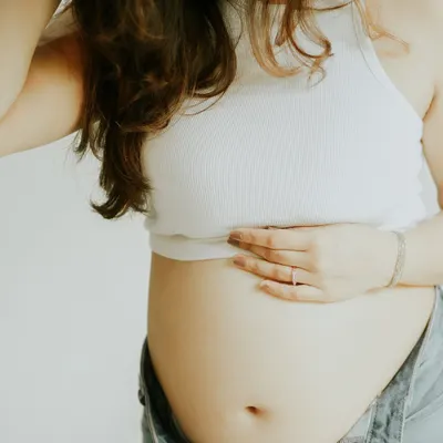 Sometimes, the bump deserves all the spotlight. This close-up shot in casual wear is perfect for camera-shy mamas who want to celebrate their pregnancy in a simple, beautiful way.