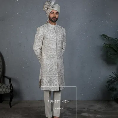 A full view of my handcrafted ivory sherwani, a reflection of India’s timeless grandeur. Paired with a feathered turban, it is designed for the groom who is ready to begin his new chapter with elegance and pride.