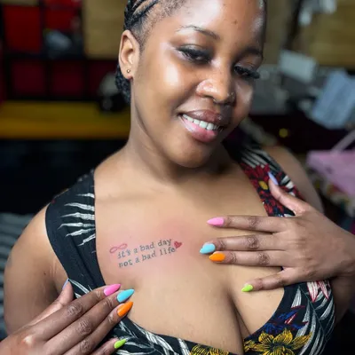 The perfect combination of fresh ink and fresh nails. This client got a meaningful quote tattoo on her chest and a vibrant, multi-colored manicure, all done right here at Zero3 Studio.