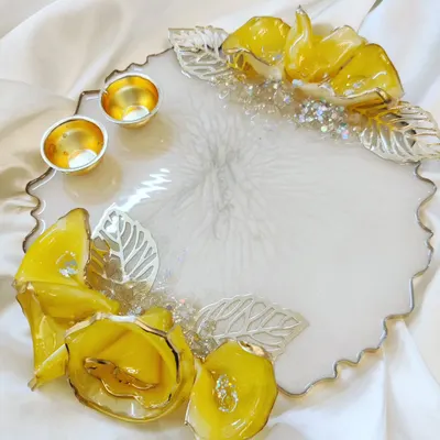 A beautiful handmade Rakhi platter or Puja Tilak Thali. This piece with 3D yellow flowers and silver leaves is perfect for Raksha Bandhan and Ganpati festivals.