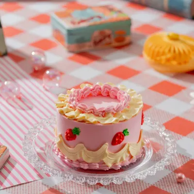 Sweet vintage vibes and strawberry delights. This Vintage Strawberry Bento Cake features charming, old-school piping details and a delicious strawberry flavor, perfect for a nostalgic treat.