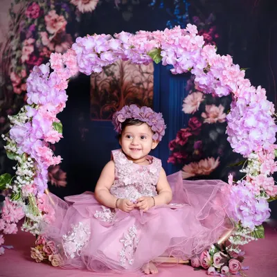 This beautiful floral swing setup is one of my most requested themes for baby girls. The soft lighting and elegant dress create a truly enchanting portrait.