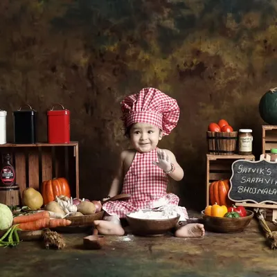 This little chef is ready to cook up some fun in our kitchen-themed setup. Complete with a chef's hat, fresh vegetables, and flour for messy play, it's a recipe for adorable photos.
