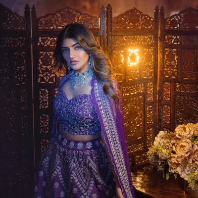 A regal purple lehenga for actress Sreeleela. The intricate silver embroidery and diamond jewelry were chosen to create a look of pure elegance for this studio photoshoot.
