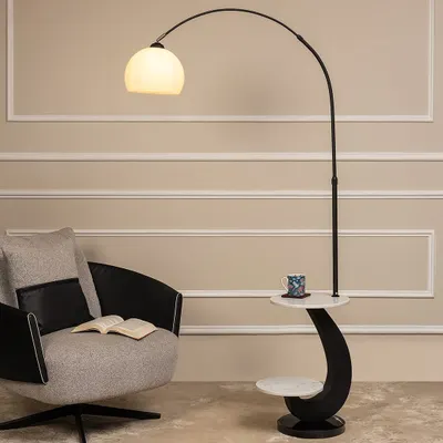 This piece is a perfect example of a multi-functional floor lamp. The arched light provides overhead illumination for a reading chair, while the integrated two-tier table offers a convenient spot for a book and a cup of tea.