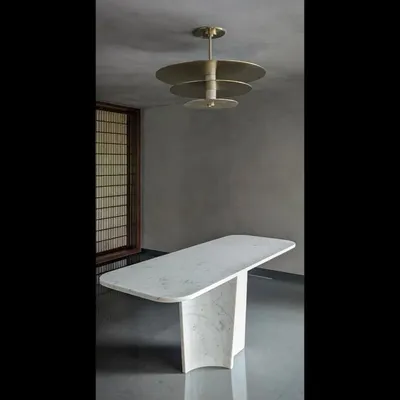 This ceiling light, designed for an entrance foyer, combines marble and brass to make a strong first impression. The tiered design plays with reflection and light, acting as a functional sculpture.
