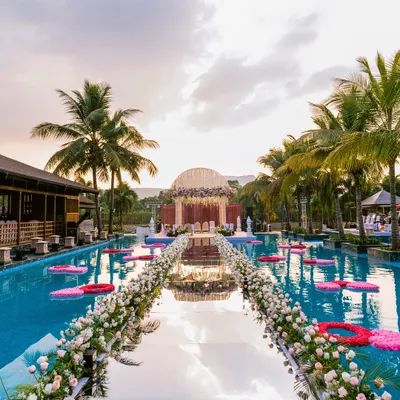 Imagine walking on water to meet your forever. For Aishwarya and Zankheel's wedding in Karjat, we captured this cinematic varmala ceremony on a mirrored aisle built over the resort pool, creating a moment that felt like a scene from a dream.