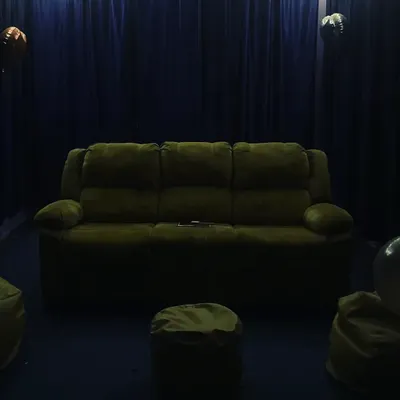 A clear view of our comfortable seating options. We have a plush three-seater recliner sofa and extra bean bags so everyone has a cozy spot to relax.