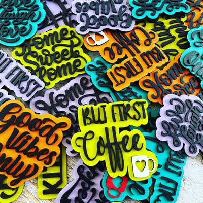 We launched a new collection of hand-painted decorative magnets! This pile shows the variety of fun quotes and bright colors available, perfect for decorating your fridge, office cabinet, or any metal surface.