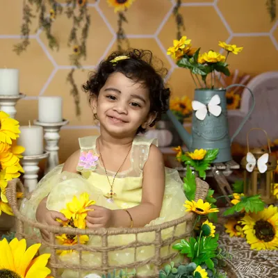 A heartwarming smile surrounded by sunflowers. This close-up from a sunflower-themed session is full of joy and brightness.