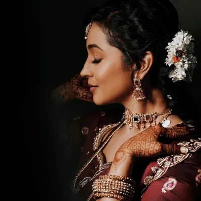 A beautiful client photo from her engagement, where you can see a glimpse of the intricate mehendi on her hands, complementing her traditional attire.
