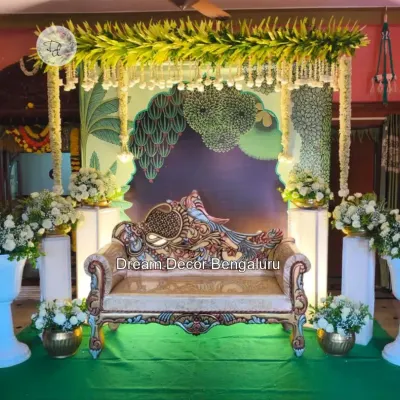 A trending Pichwai decor I did for an engagement. The peacock-themed sofa and the artistic backdrop with lush greenery create a royal and traditional ambiance.